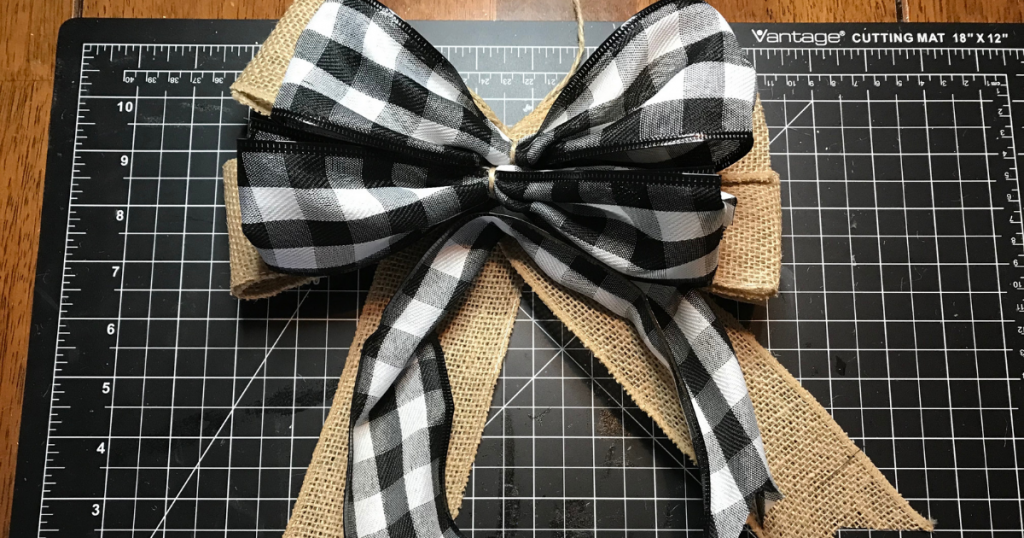 lay the wired buffalo plaid bow on top of the burlap bow to make a double layered bow for wreaths