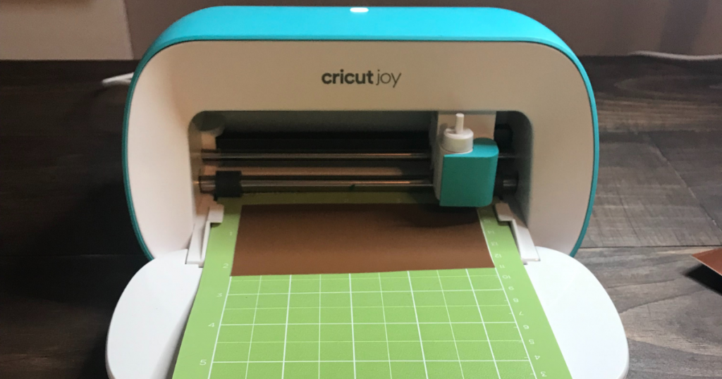 Cricut Joy cutting the vinyl scraps for the DIY wood slice craft