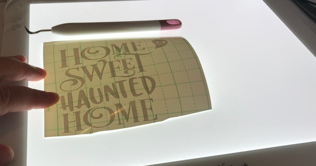 Weed the vinyl design to add to the fall Cricut Signs