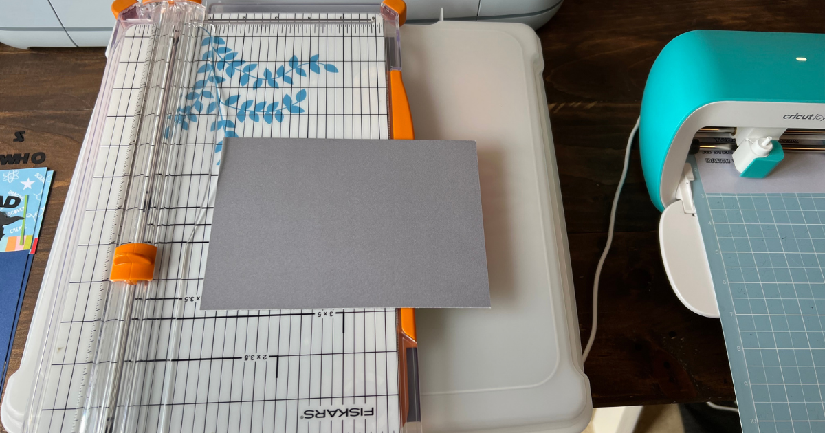 using the paper trimmer to cut the card base